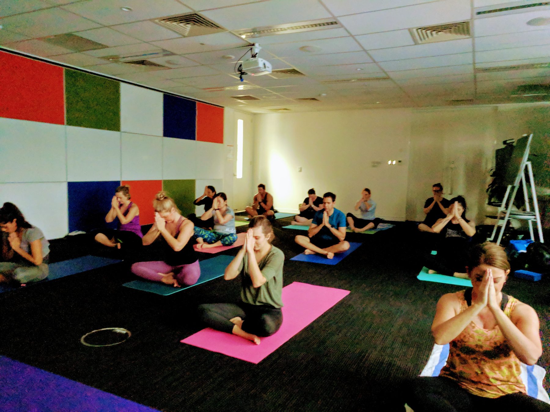 A group of colleagues seated in a mindful breathing session